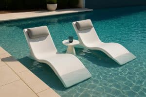 Stylish in-pool loungers and chairs enhance a luxurious backyard swimming pool setup