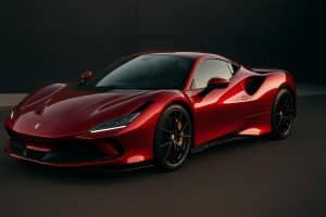 Sleek red exotic sports car parked on a scenic road highlighting luxury automotive features