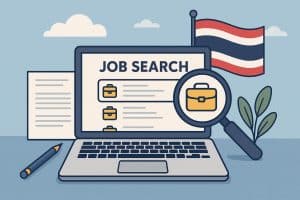 Laptop displaying Thai job search website with magnifying glass, representing online job hunting